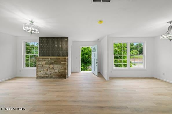 739 W Main St, Sevierville, TN 37862 - unfurnished living room with a chandelier, healthy amount of natural light, and baseboards