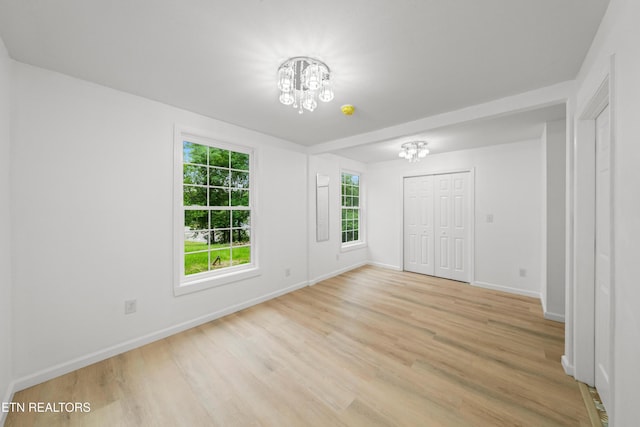 739 W Main St, Sevierville, TN 37862 - unfurnished bedroom with a chandelier, baseboards, light wood finished floors, and a closet