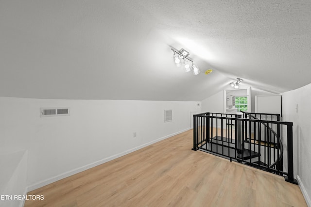 739 W Main St, Sevierville, TN 37862 - bonus room with wood finished floors, lofted ceiling, baseboards, and a textured ceiling