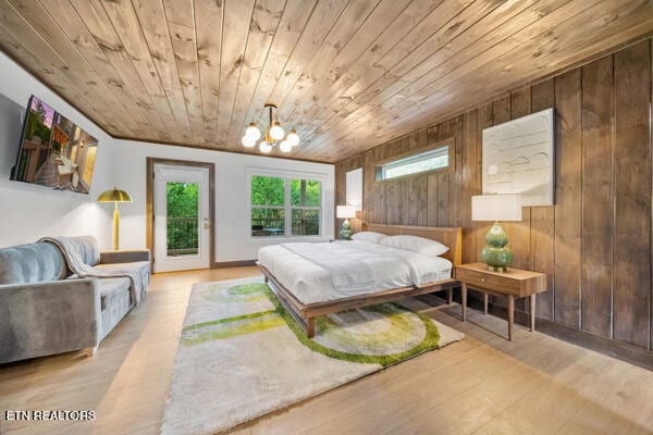 bedroom with wood ceiling, a chandelier, access to outside, wood finished floors, and wood walls