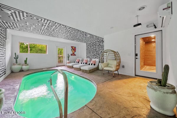 view of swimming pool with a wall mounted air conditioner
