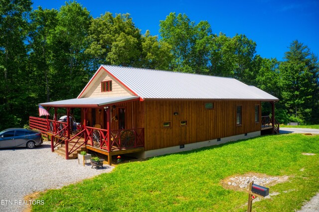 305 Griffin Ln, Allardt, TN 38504 - view of front of home with a porch, crawl space, a front lawn, and metal roof