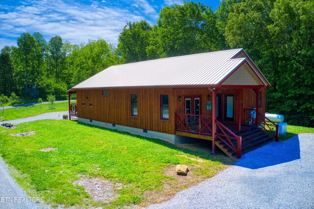 305 Griffin Ln, Allardt, TN 38504 - rustic home featuring a porch, a front yard, a standing seam roof, metal roof, and crawl space