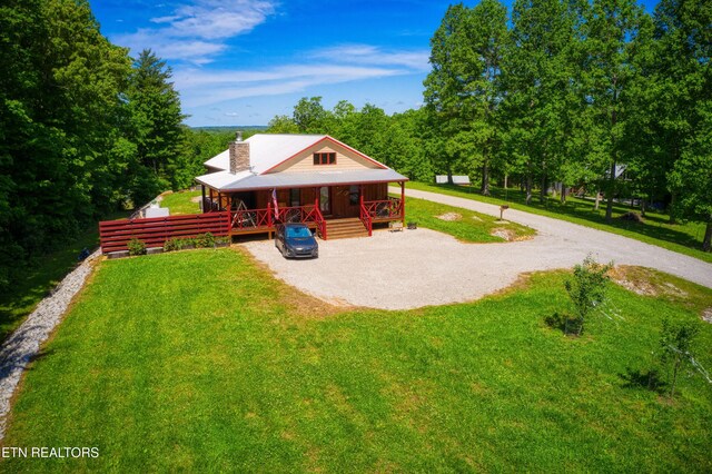 305 Griffin Ln, Allardt, TN 38504 - view of grassy yard featuring a porch and gravel driveway