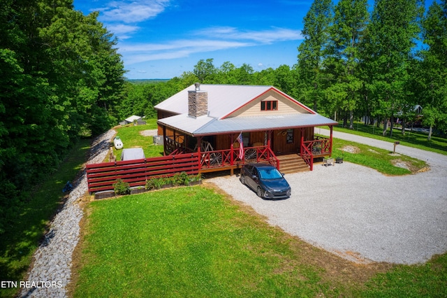 305 Griffin Ln, Allardt, TN 38504 - rustic home with a porch, gravel driveway, a chimney, and a front lawn