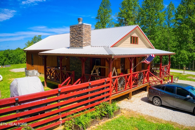 305 Griffin Ln, Allardt, TN 38504 - view of front facade with a chimney, a porch, and metal roof