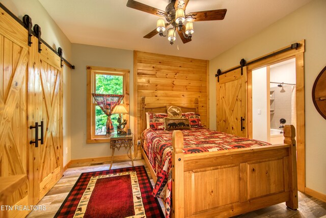 305 Griffin Ln, Allardt, TN 38504 - bedroom featuring a barn door, baseboards, and a ceiling fan