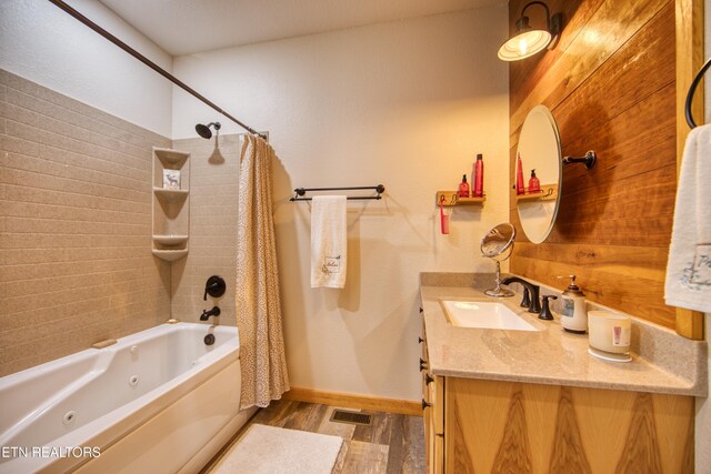 305 Griffin Ln, Allardt, TN 38504 - bathroom featuring a combined bath / shower with jetted tub, wood finished floors, vanity, and baseboards