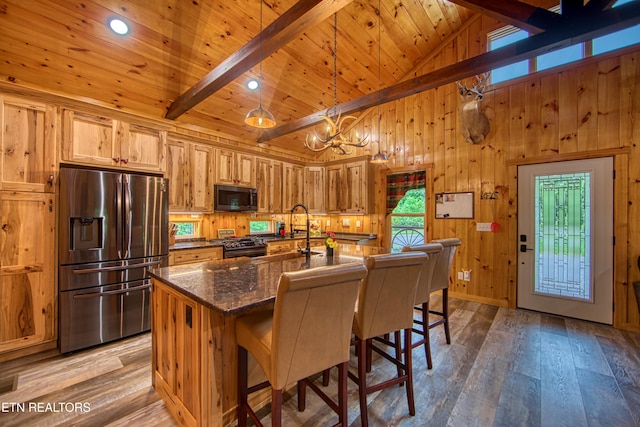 305 Griffin Ln, Allardt, TN 38504 - kitchen featuring stainless steel appliances, wood-type flooring, wooden walls, a breakfast bar, and high vaulted ceiling
