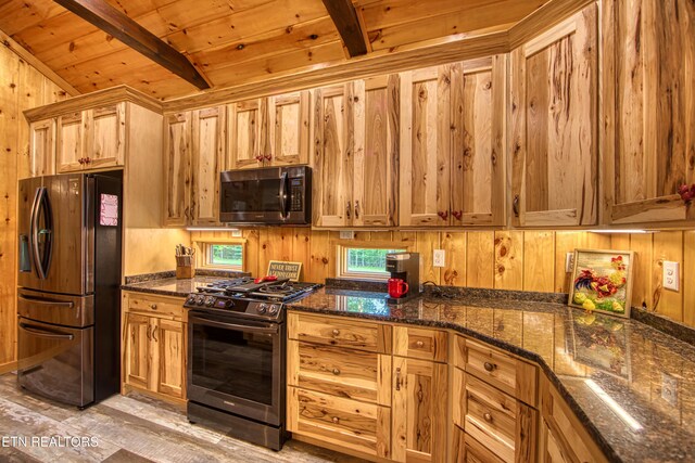 305 Griffin Ln, Allardt, TN 38504 - kitchen featuring appliances with stainless steel finishes, wooden walls, wooden ceiling, and dark stone countertops