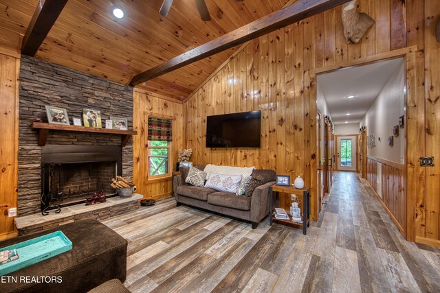 305 Griffin Ln, Allardt, TN 38504 - living room featuring wood finished floors, wood walls, wooden ceiling, a fireplace, and ceiling fan