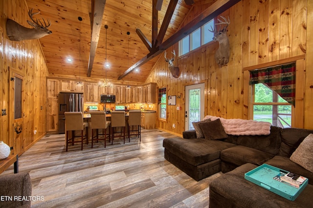 305 Griffin Ln, Allardt, TN 38504 - living room with high vaulted ceiling, light wood finished floors, wooden walls, and wood ceiling with exposed beams