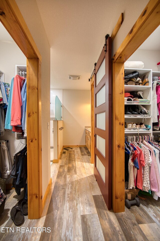 305 Griffin Ln, Allardt, TN 38504 - spacious closet with a barn door and hardwood / wood-style flooring