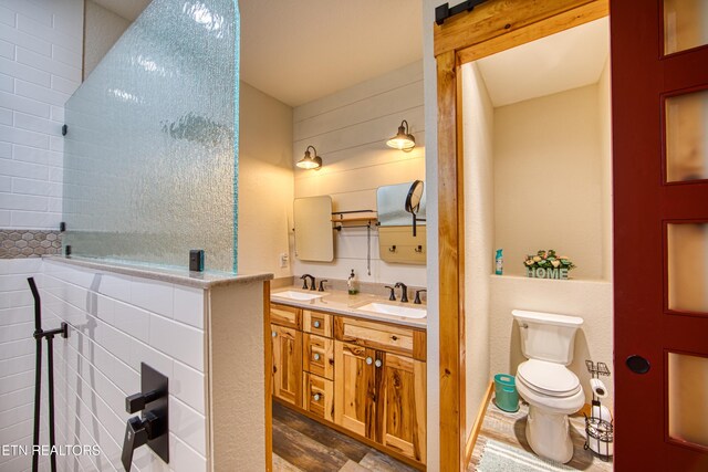 305 Griffin Ln, Allardt, TN 38504 - bathroom featuring double vanity, toilet, and tiled shower