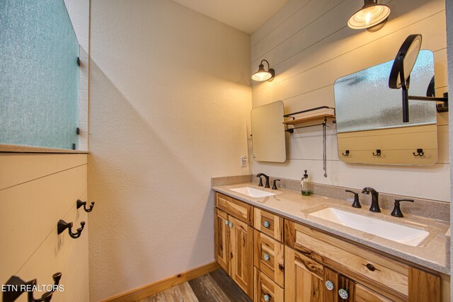 305 Griffin Ln, Allardt, TN 38504 - bathroom with double vanity, wood finished floors, and baseboards