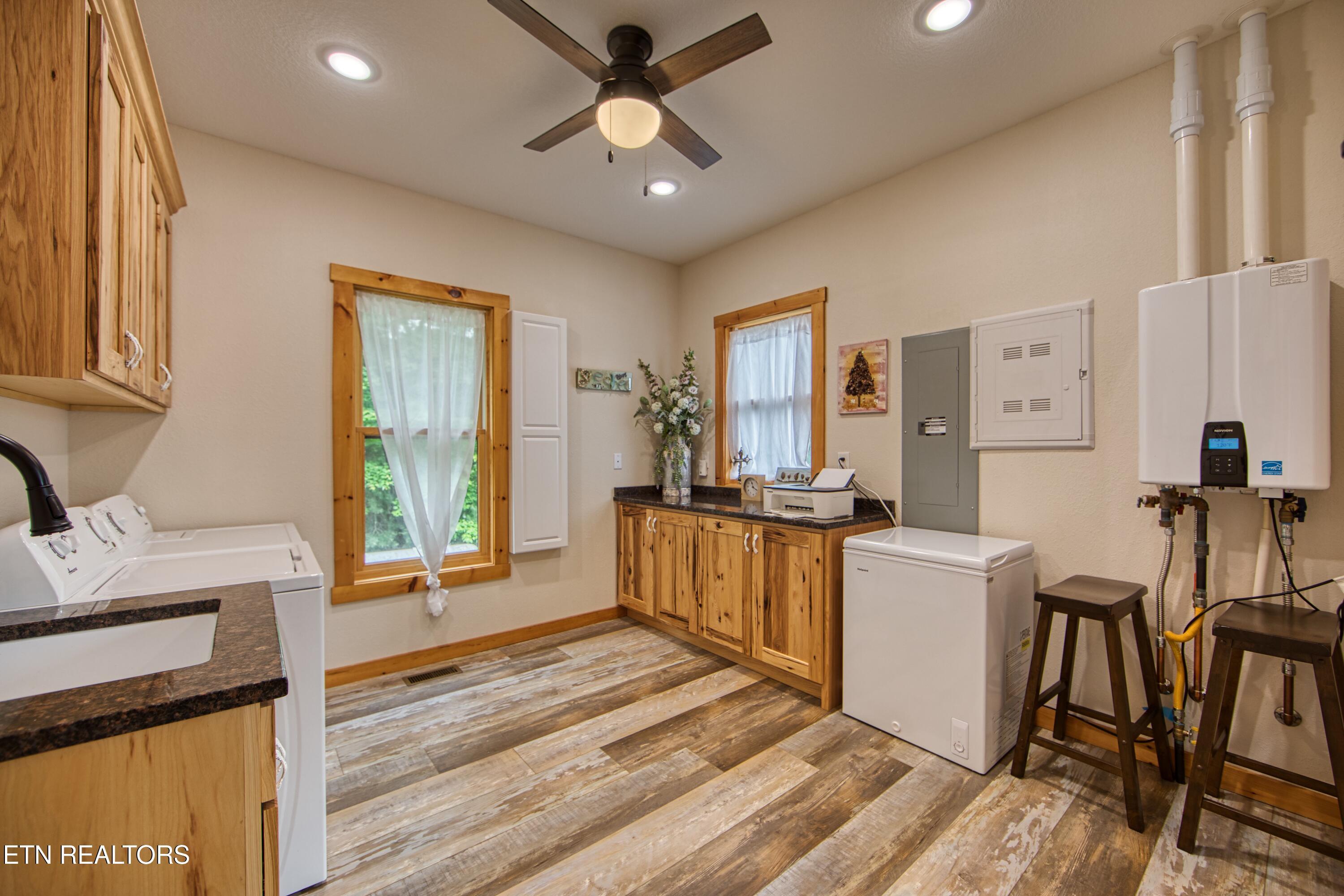 305 Griffin Ln, Allardt, TN 38504 - washroom featuring a ceiling fan, tankless water heater, light wood-style floors, washer and dryer, and recessed lighting