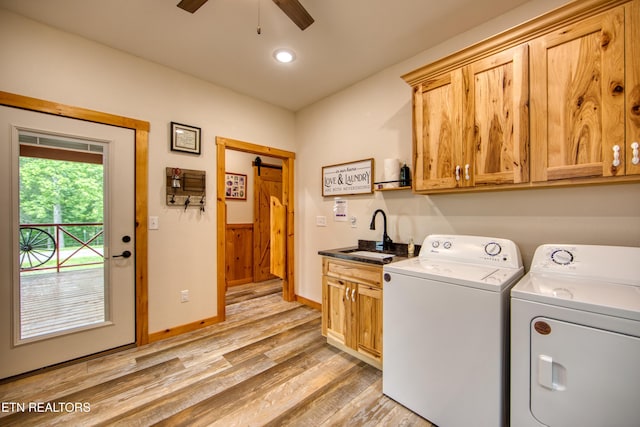 305 Griffin Ln, Allardt, TN 38504 - washroom featuring washer and clothes dryer, cabinet space, ceiling fan, light wood finished floors, and a barn door
