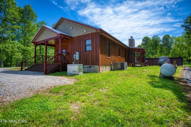 305 Griffin Ln, Allardt, TN 38504 - view of property exterior with a chimney, a lawn, cooling unit, and ac unit