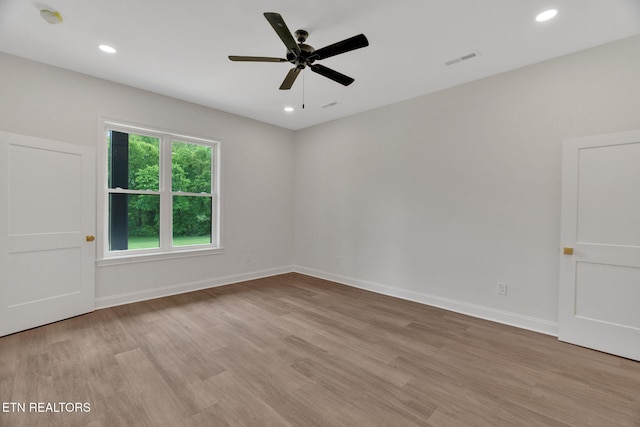 empty room with light wood-style floors, a ceiling fan, recessed lighting, and baseboards