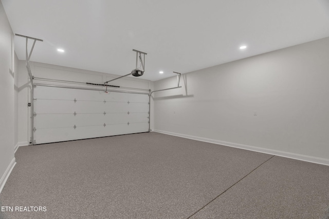 garage featuring a garage door opener, baseboards, and recessed lighting