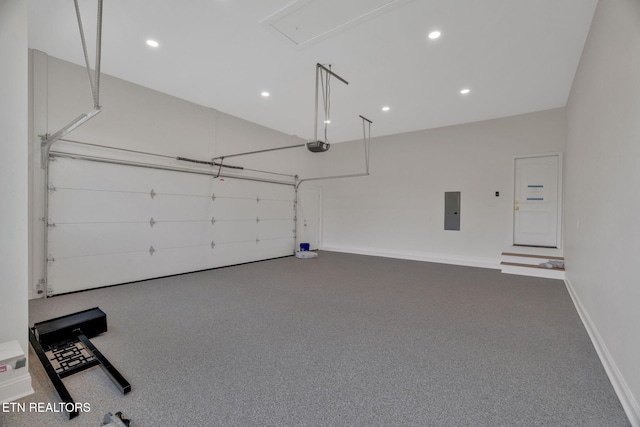 garage featuring electric panel, a garage door opener, recessed lighting, and baseboards