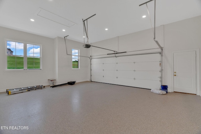 garage featuring a garage door opener and recessed lighting