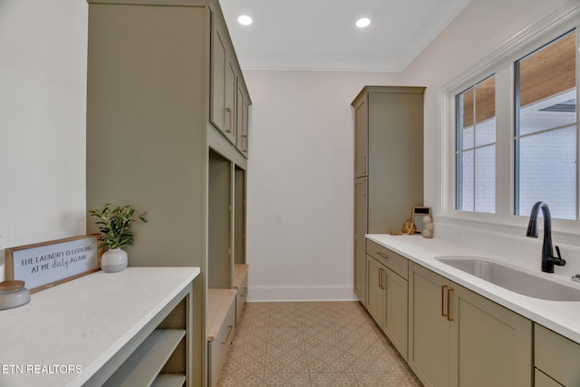 kitchen with a sink, light floors, light countertops, recessed lighting, and gray cabinets
