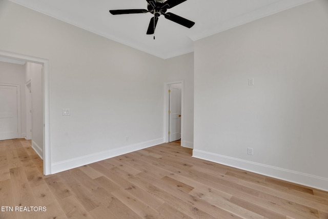 unfurnished room with ceiling fan, light wood-type flooring, baseboards, and ornamental molding