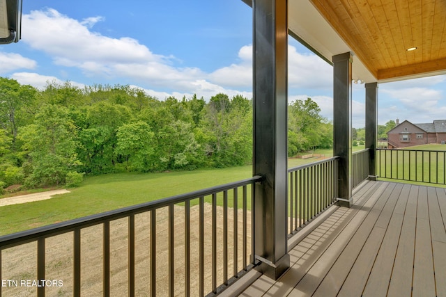 wooden deck featuring a yard