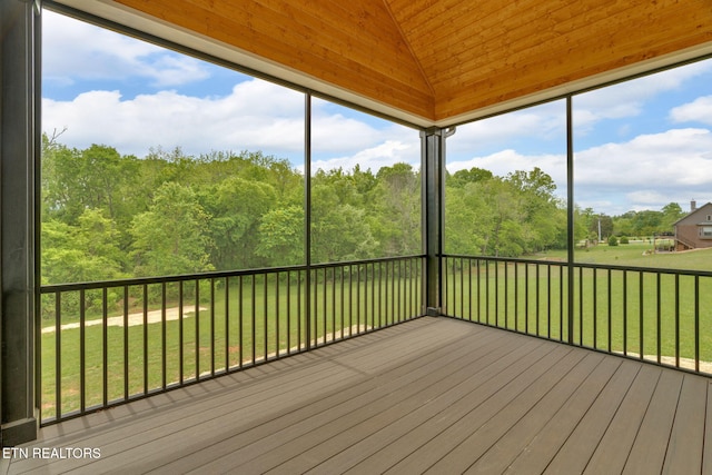 unfurnished sunroom featuring lofted ceiling