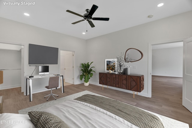 bedroom featuring wood finished floors, recessed lighting, and baseboards