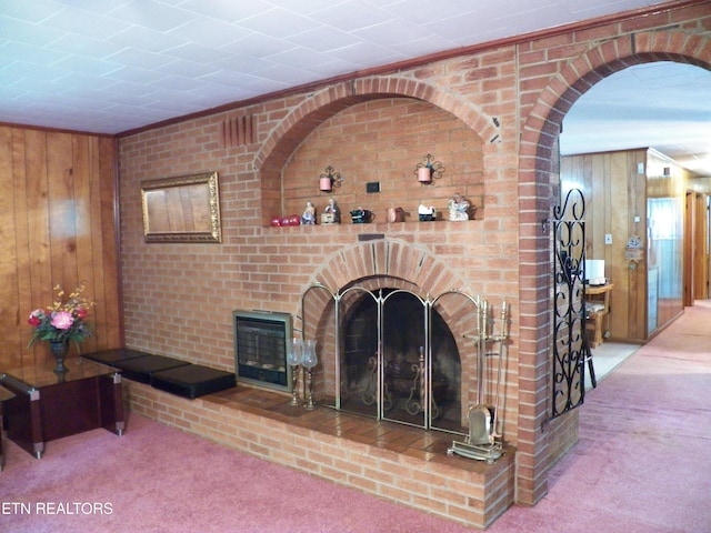 1634 Snodderly Dr, Lenoir City, TN 37771 - carpeted living room featuring wood walls and a fireplace