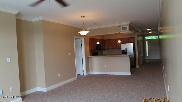 kitchen with carpet, crown molding, a ceiling fan, black microwave, and baseboards