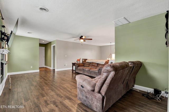 1023 NE Old Charleston Rd, Cleveland, TN 37312 - living room featuring ceiling fan, a textured ceiling, dark wood-style flooring, and baseboards