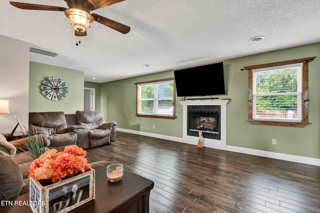 1023 NE Old Charleston Rd, Cleveland, TN 37312 - living room featuring ceiling fan, a fireplace, baseboards, hardwood / wood-style floors, and a textured ceiling