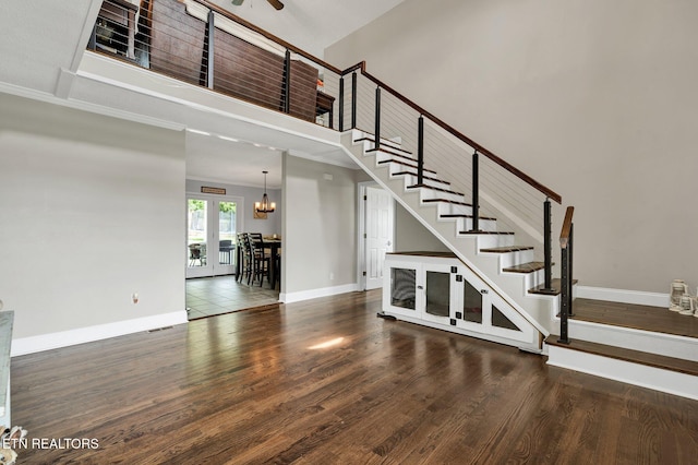 1023 NE Old Charleston Rd, Cleveland, TN 37312 - staircase featuring baseboards, wood finished floors, crown molding, a chandelier, and a ceiling fan