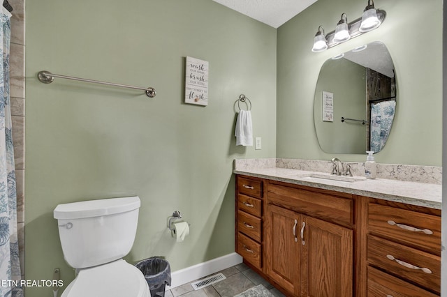 1023 NE Old Charleston Rd, Cleveland, TN 37312 - bathroom featuring baseboards, toilet, vanity, and tile patterned flooring