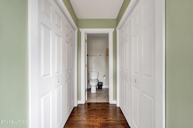 1023 NE Old Charleston Rd, Cleveland, TN 37312 - corridor featuring a textured ceiling, baseboards, and dark wood-style flooring