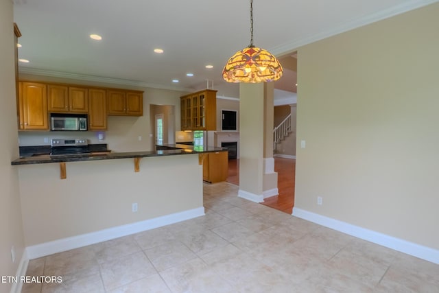 1419 Cheyenne Blvd, Seymour, TN 37865 - kitchen featuring appliances with stainless steel finishes, ornamental molding, brown cabinetry, a kitchen bar, and recessed lighting