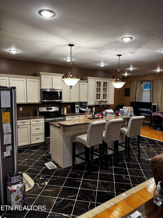 900 Twin Fawn Trl, Middlesboro, KY 40965 - kitchen with appliances with stainless steel finishes, a kitchen bar, white cabinetry, and recessed lighting