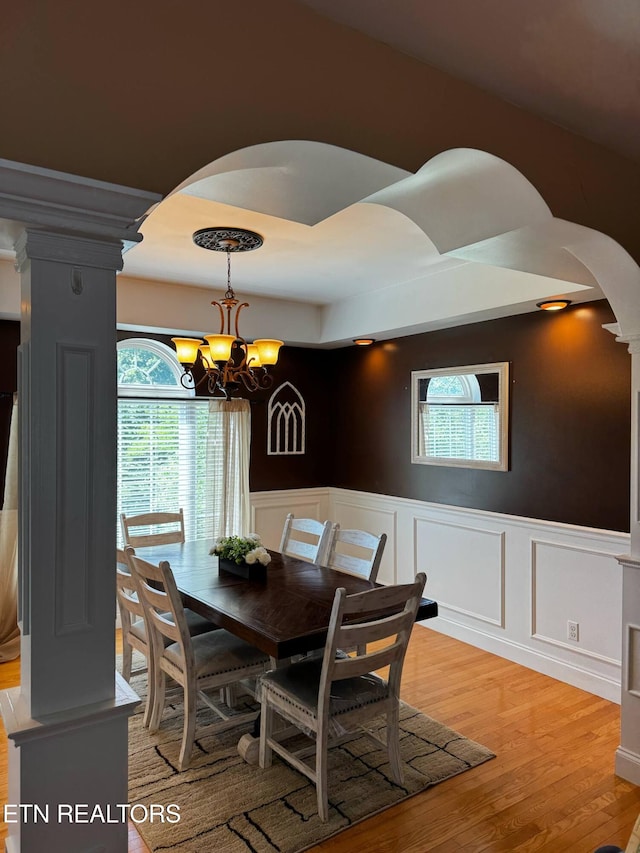 900 Twin Fawn Trl, Middlesboro, KY 40965 - dining area featuring arched walkways, wainscoting, a chandelier, plenty of natural light, and decorative columns