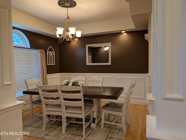 900 Twin Fawn Trl, Middlesboro, KY 40965 - dining area with a decorative wall, a chandelier, light wood-style floors, and wainscoting