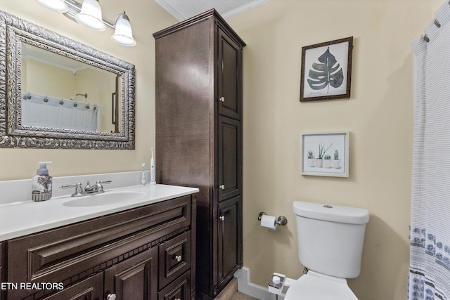 full bathroom featuring ornamental molding, toilet, and vanity