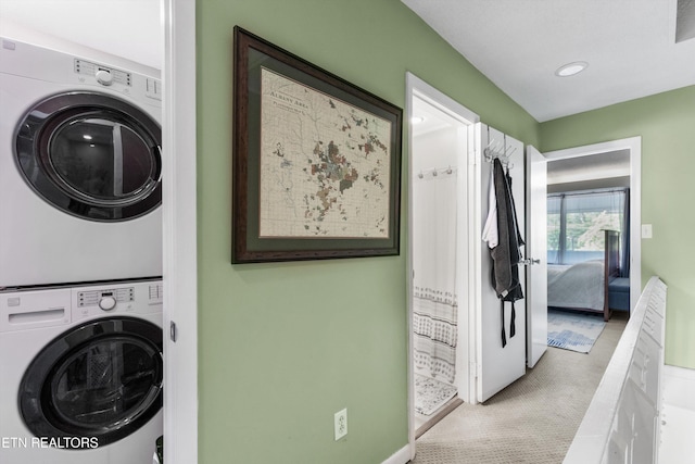clothes washing area with stacked washer and clothes dryer, recessed lighting, and carpet flooring