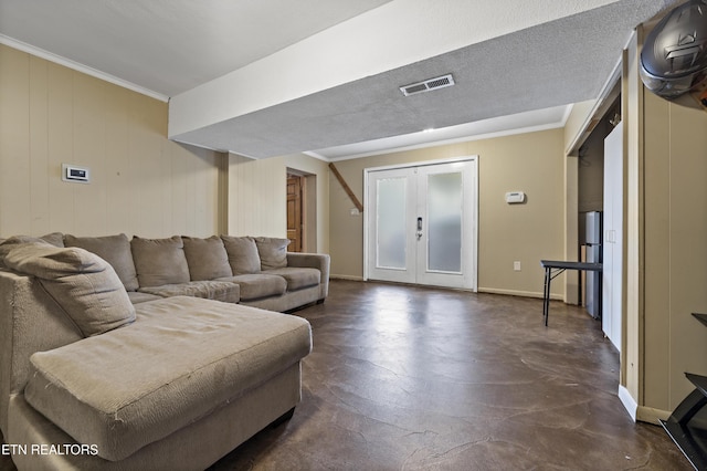 living room with finished concrete flooring, baseboards, and crown molding