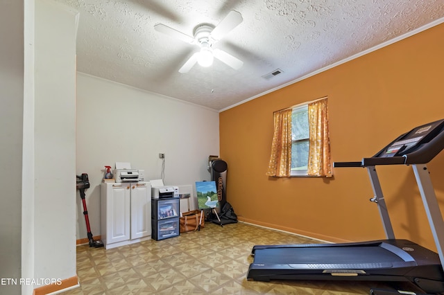 workout area with a textured ceiling, ceiling fan, baseboards, light flooring, and ornamental molding