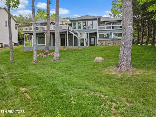 118 Motthaven Dr, Crossville, TN 38558 - rear view of property featuring a deck, a lawn, stone siding, and central AC