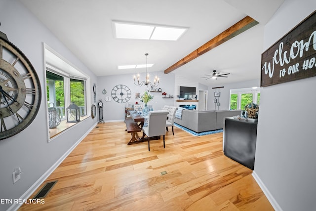 118 Motthaven Dr, Crossville, TN 38558 - dining room with light wood-type flooring, a chandelier, a skylight, and baseboards