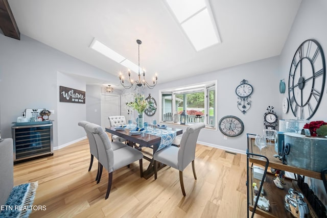 118 Motthaven Dr, Crossville, TN 38558 - dining area featuring vaulted ceiling, beverage cooler, a chandelier, light wood finished floors, and baseboards