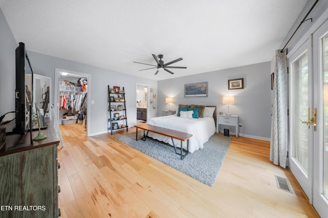 118 Motthaven Dr, Crossville, TN 38558 - bedroom featuring light wood-type flooring, a walk in closet, baseboards, and a closet